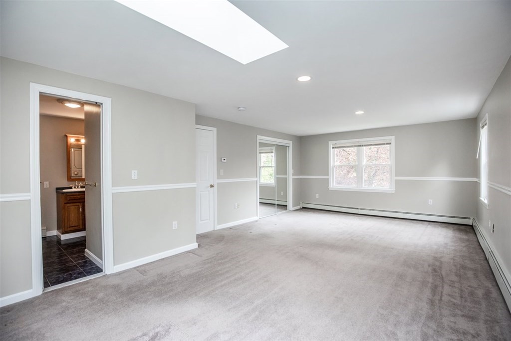 84 Browning Road Arlington, MA 02476 - Photo 15 of 37 an empty room with windows and pillars in it