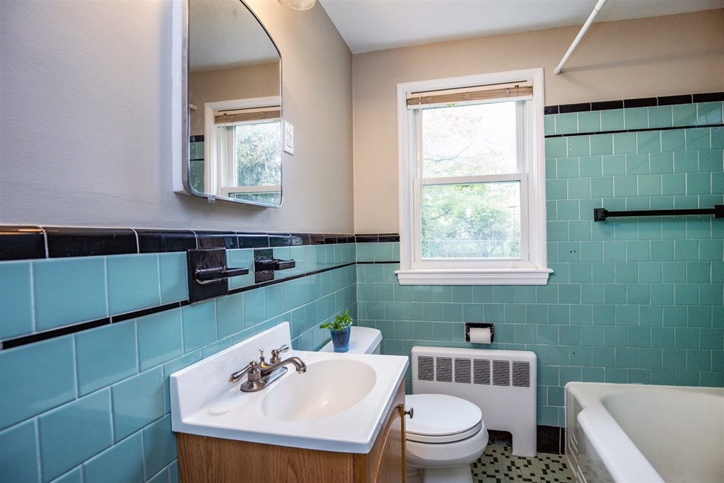 84 Browning Road Arlington, MA 02476 - Photo 21 of 37 a bathroom with a sink a toilet and a window