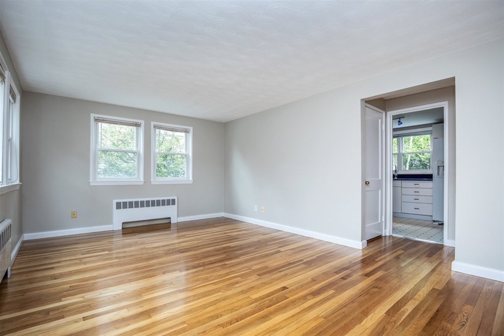 84 Browning Road Arlington, MA 02476 - Photo 6 of 37 a view of empty room with wooden floor and fan
