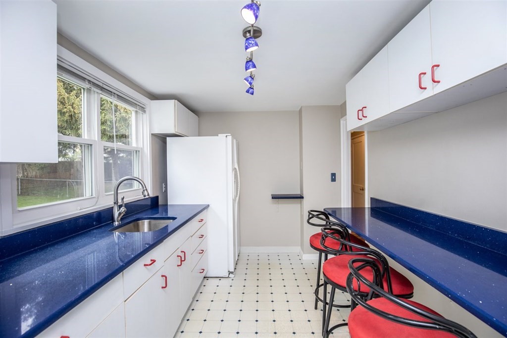 84 Browning Road Arlington, MA 02476 - Photo 8 of 37 a kitchen that has a sink cabinets and window