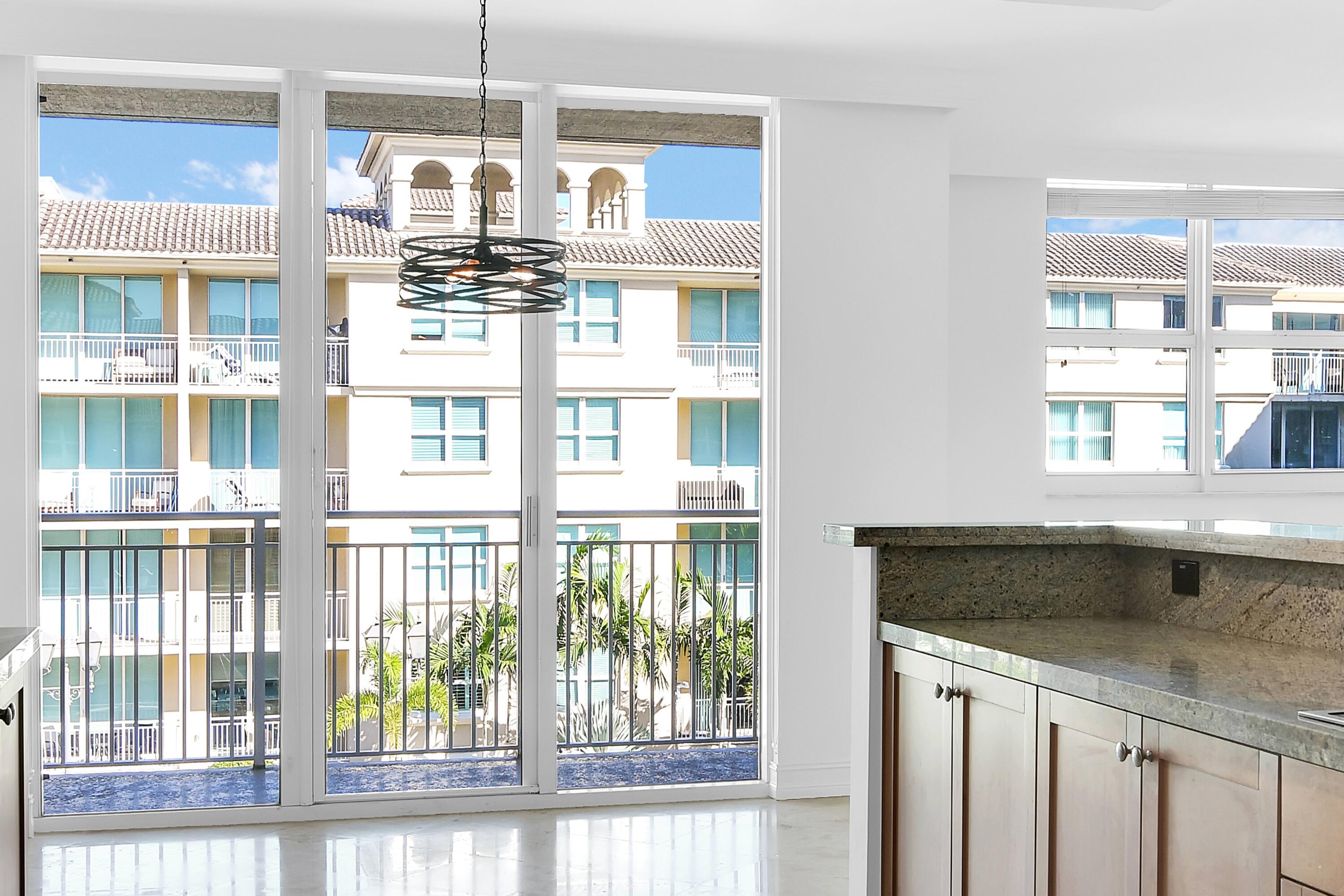 99 Southeast Mizner Boulevard, Unit PH 40 Boca Raton, FL 33432 - Photo 14 of 48 a kitchen with a window and chandelier