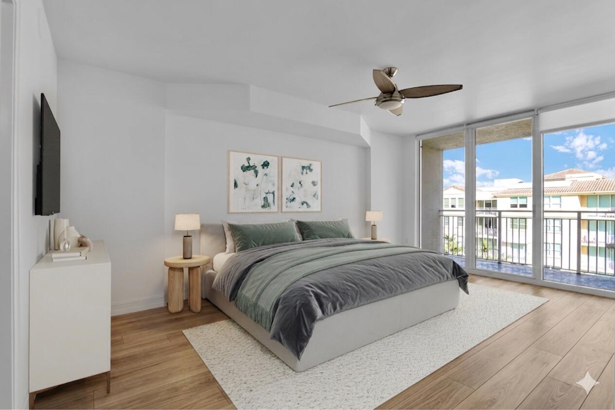 99 Southeast Mizner Boulevard, Unit PH 40 Boca Raton, FL 33432 - Photo 22 of 48 a spacious bedroom with a large bed and a large window