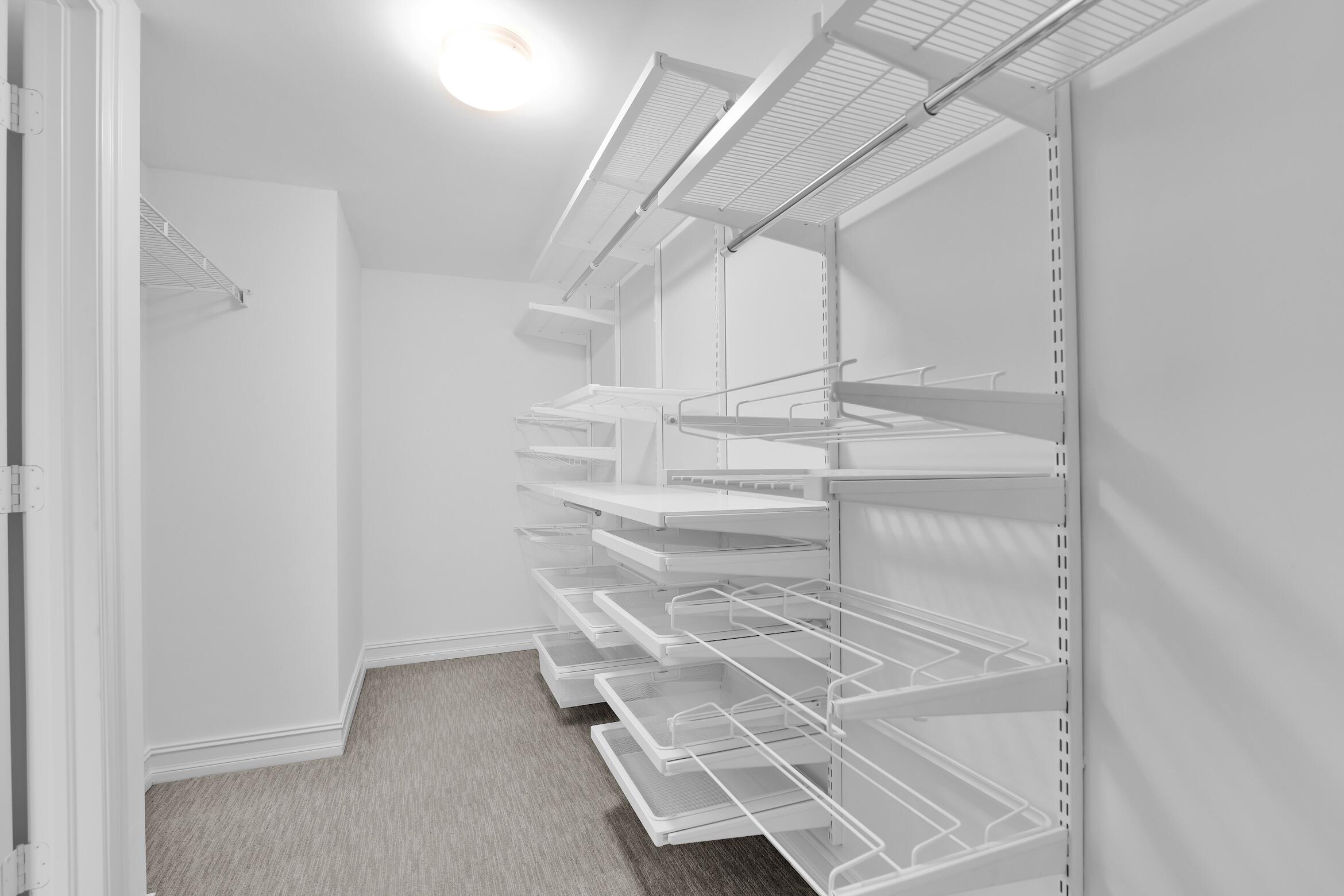 99 Southeast Mizner Boulevard, Unit PH 40 Boca Raton, FL 33432 - Photo 27 of 48 a view of walk in closet with empty racks