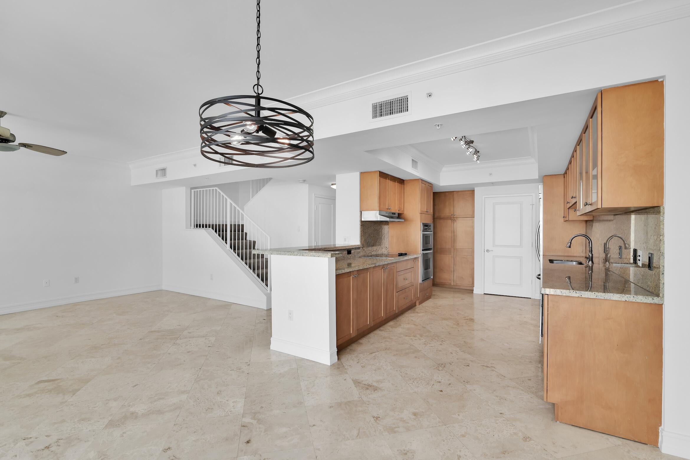 99 Southeast Mizner Boulevard, Unit PH 40 Boca Raton, FL 33432 - Photo 3 of 48 a kitchen with refrigerator and window