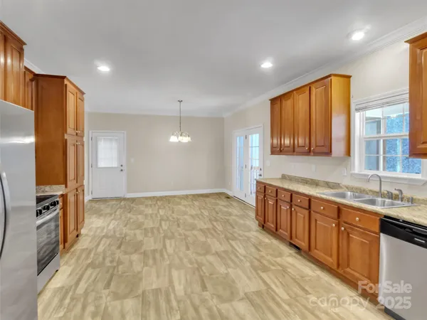 a view of an empty room with cabinet and fan