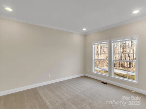 a view of a kitchen with white cabinets and wooden floor