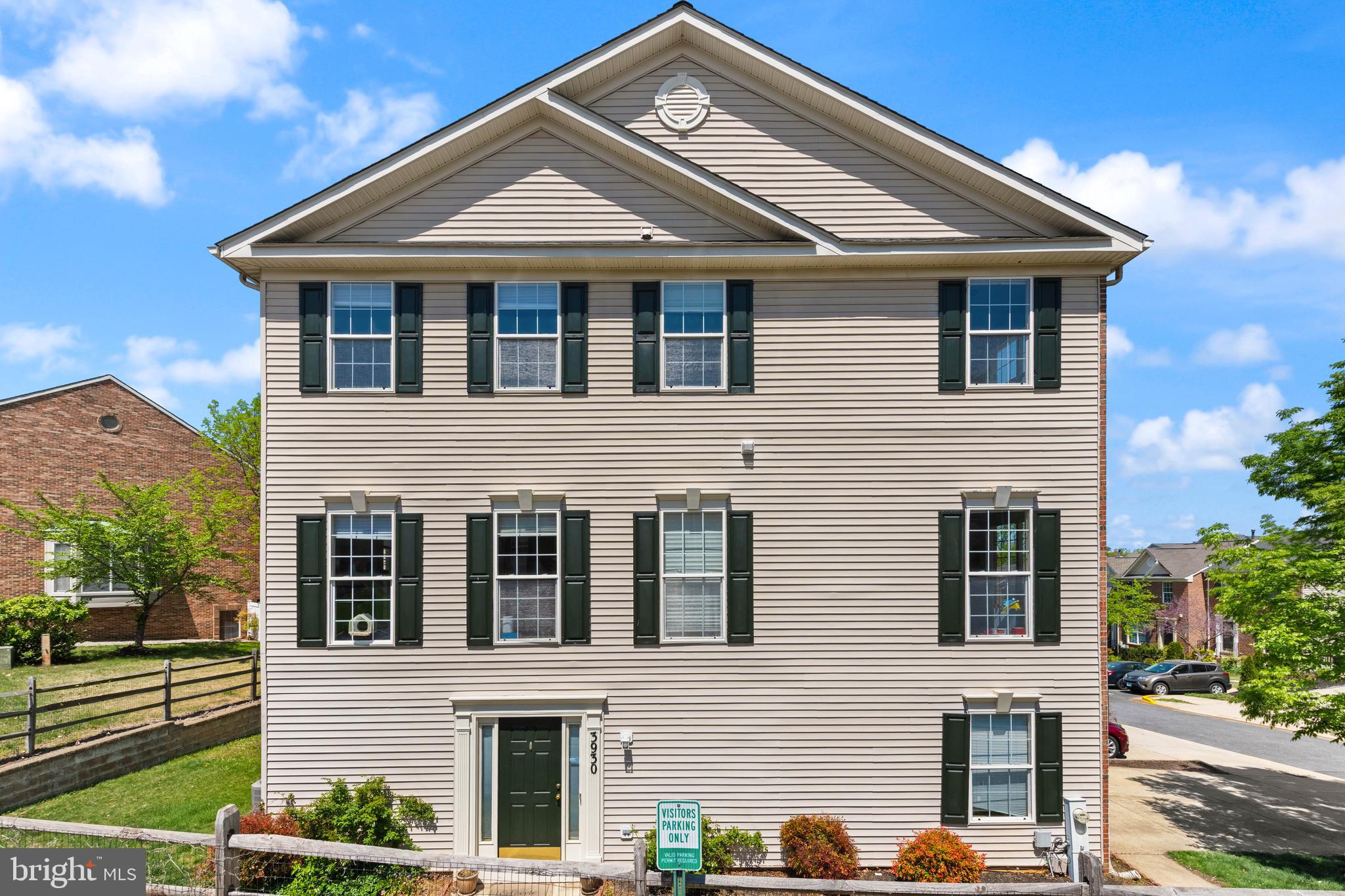 a front view of a house with plants