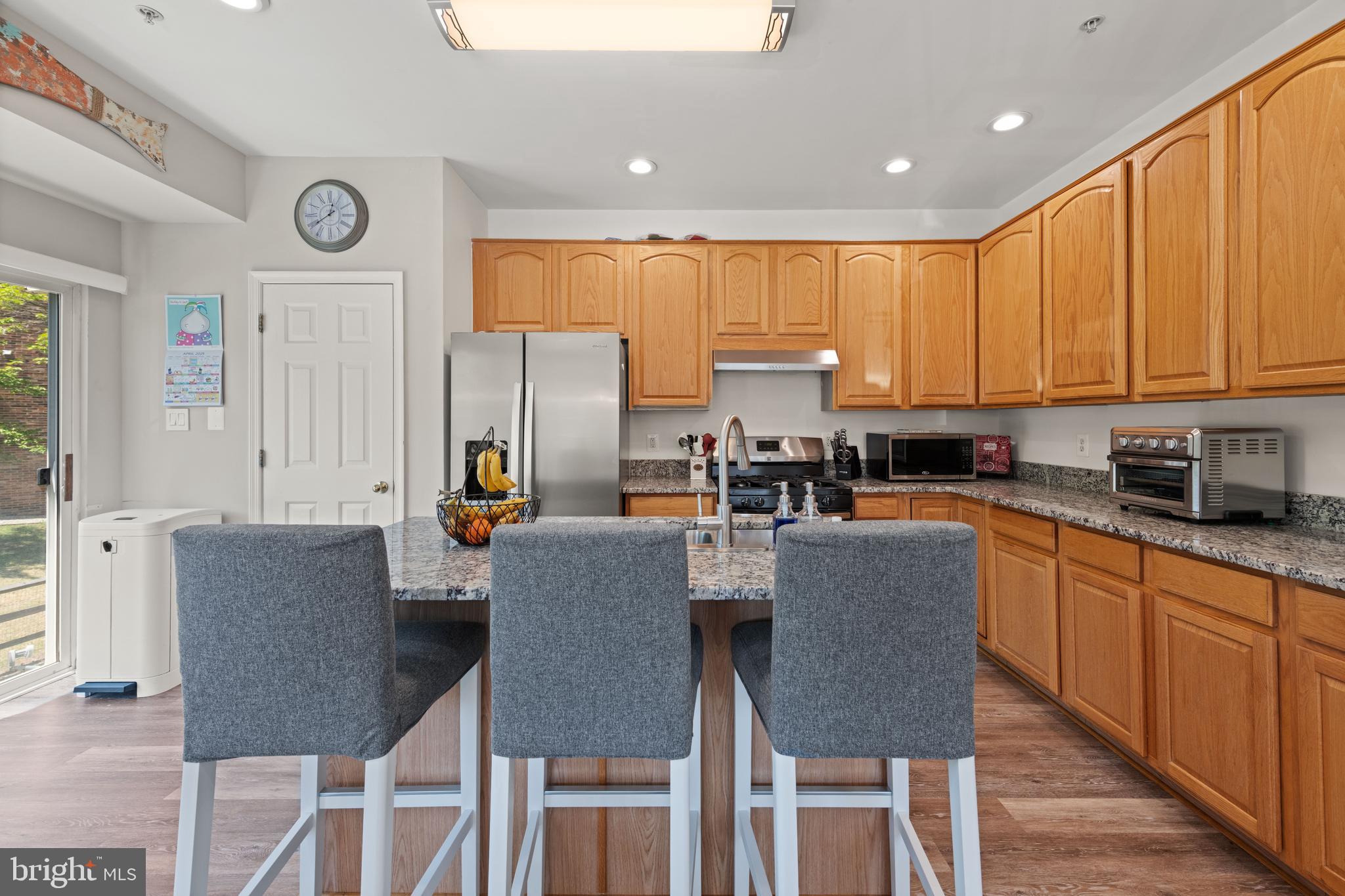3930 Ballet Way Burtonsville, MD 20866 - Photo 17 of 36 a kitchen with a table chairs microwave and cabinets