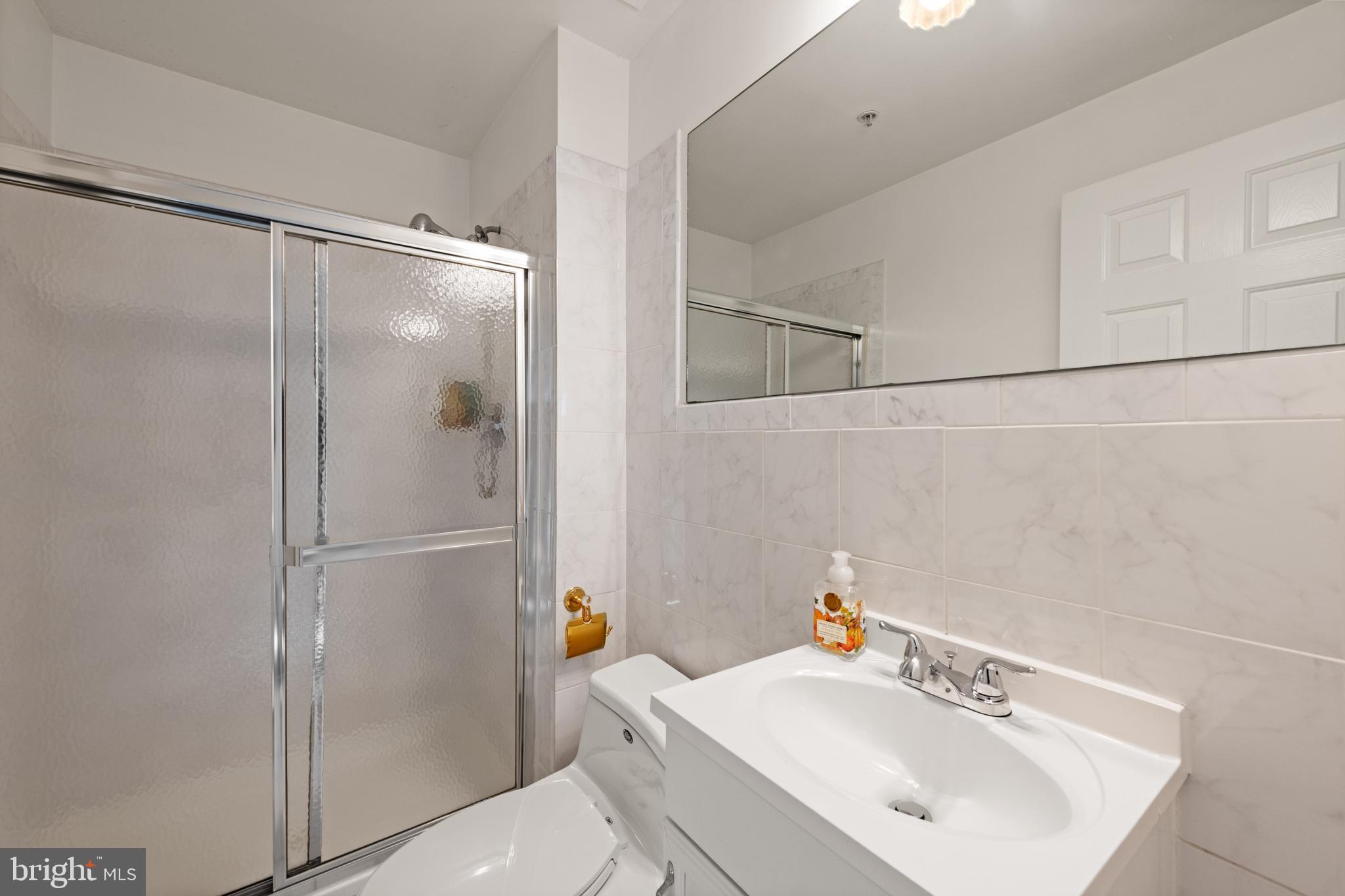 3930 Ballet Way Burtonsville, MD 20866 - Photo 8 of 36 a bathroom with a sink a mirror and a shower