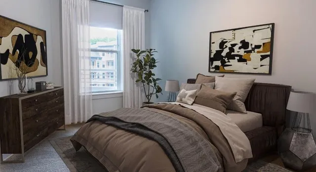 a bed sitting in a bedroom next to a window