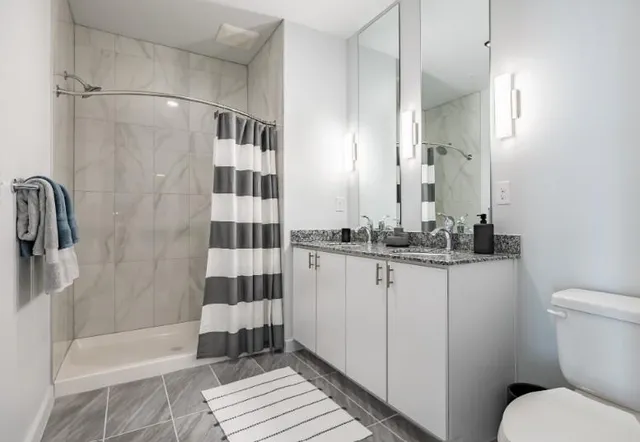 a bathroom with a sink toilet and shower