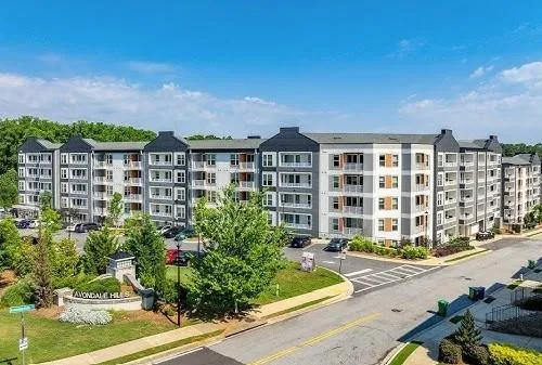 a living room with furniture a flat screen tv and a table