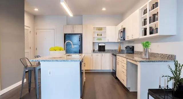 a kitchen with a sink a stove and cabinets