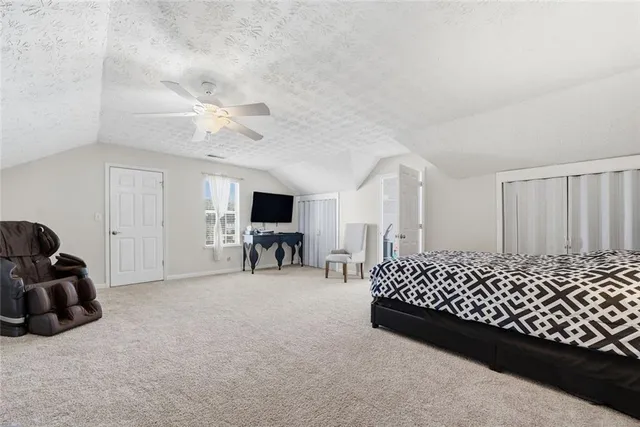 a bedroom with furniture and a large window