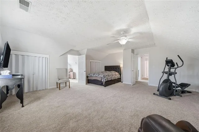 a living room with furniture a flat screen tv and a window