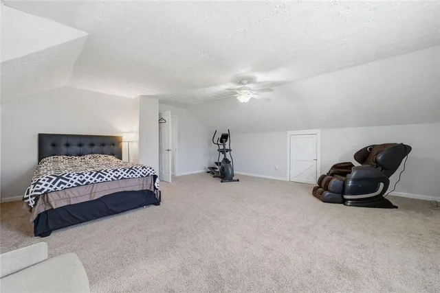 a bedroom with a bed and a chair