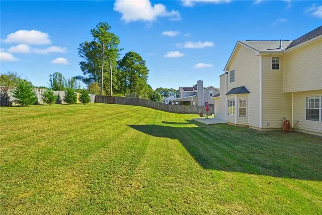 a view of a big yard with a house