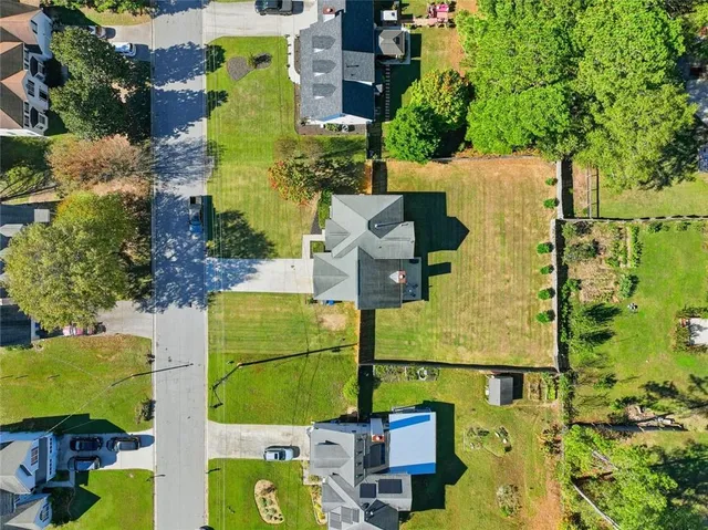 an aerial view of residential houses with yard