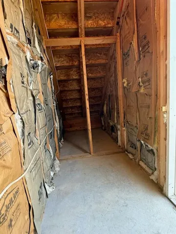 a view of walk in closet with clothes