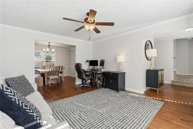a living room with furniture a rug and a chandelier