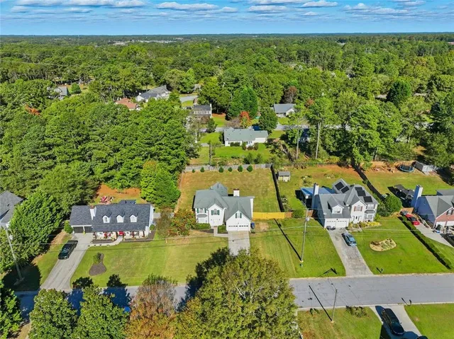 an aerial view of residential houses with outdoor space
