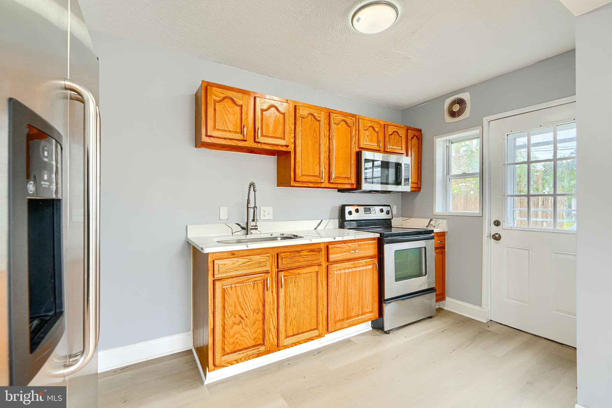 1902 Kelmore Road Baltimore, MD 21222 - Photo 7 of 27 KITCHEN w/ GRANITE COUNTERS