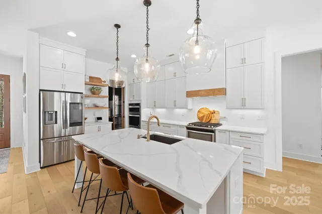 a kitchen with granite countertop white cabinets and white appliances
