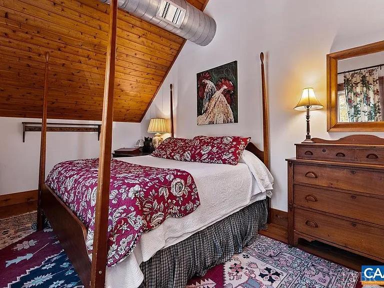 325 Old Roseland Road Roseland, VA 22967 - Photo 52 of 69 a bedroom with a bed a dresser and paintings on the wall