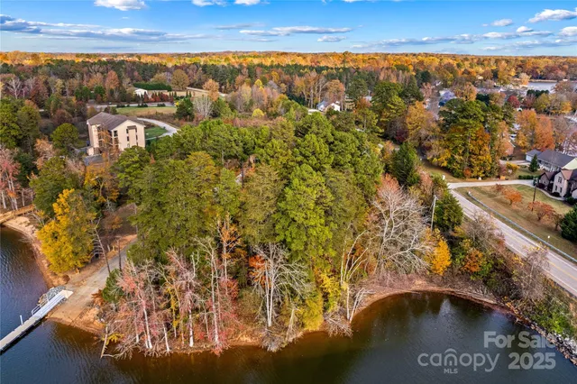 a view of residential houses with outdoor space and lake view