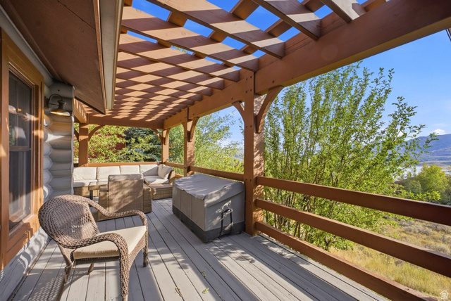 12465 Bone Road Kamas, UT 84036 - Photo 19 of 63 Expansive wood deck with a slatted pergola, log-style exterior, and wood railing