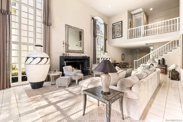 a living room with furniture fireplace and a window