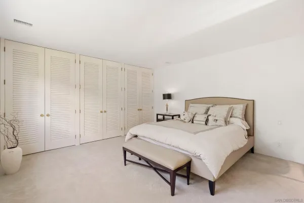 a bedroom with a bed and a table