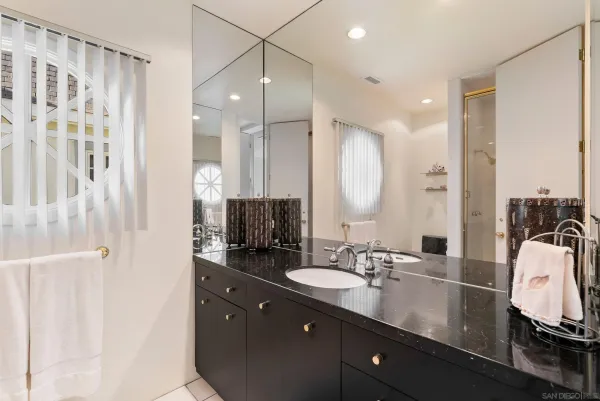 a bathroom with a double vanity sink and a mirror