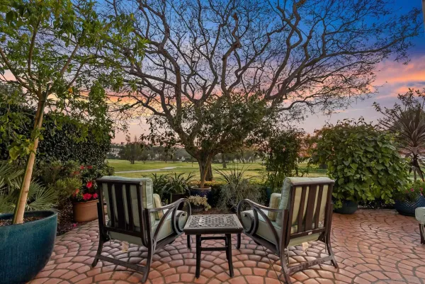 a view of backyard with seating and green space