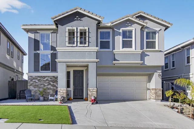 a front view of a house with a yard and garage