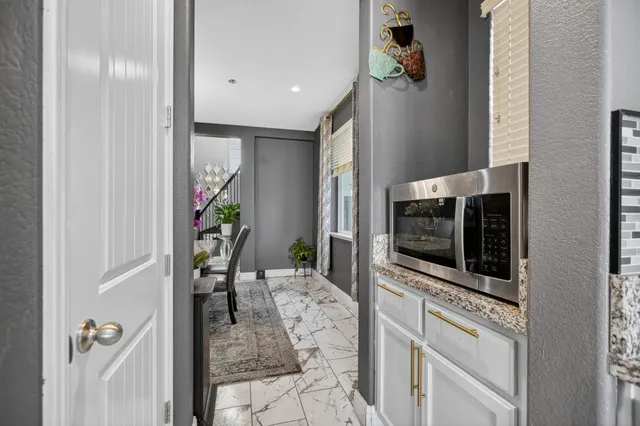 an empty room with a window and wooden floor