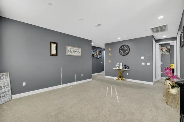 a room with a bed and a large mirror on the dresser