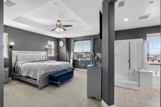 a white bath tub sitting in a bathroom next to a window