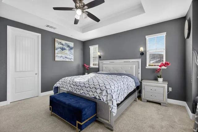 a bedroom with a bed and a painting on the wall