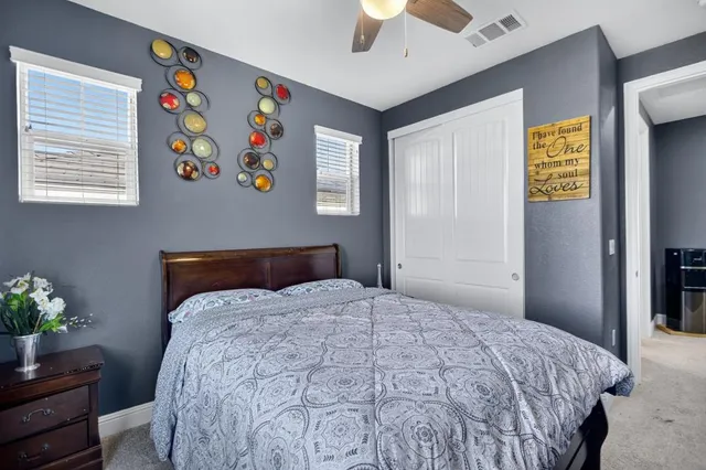 a bedroom with bed and a bookshelf