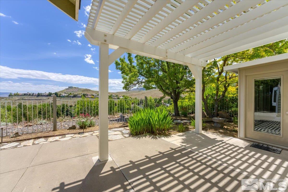 2736 Starr Meadows Loop Reno, NV 89519 - Photo 23 of 40 a view of a patio with a table and chairs next to a yard