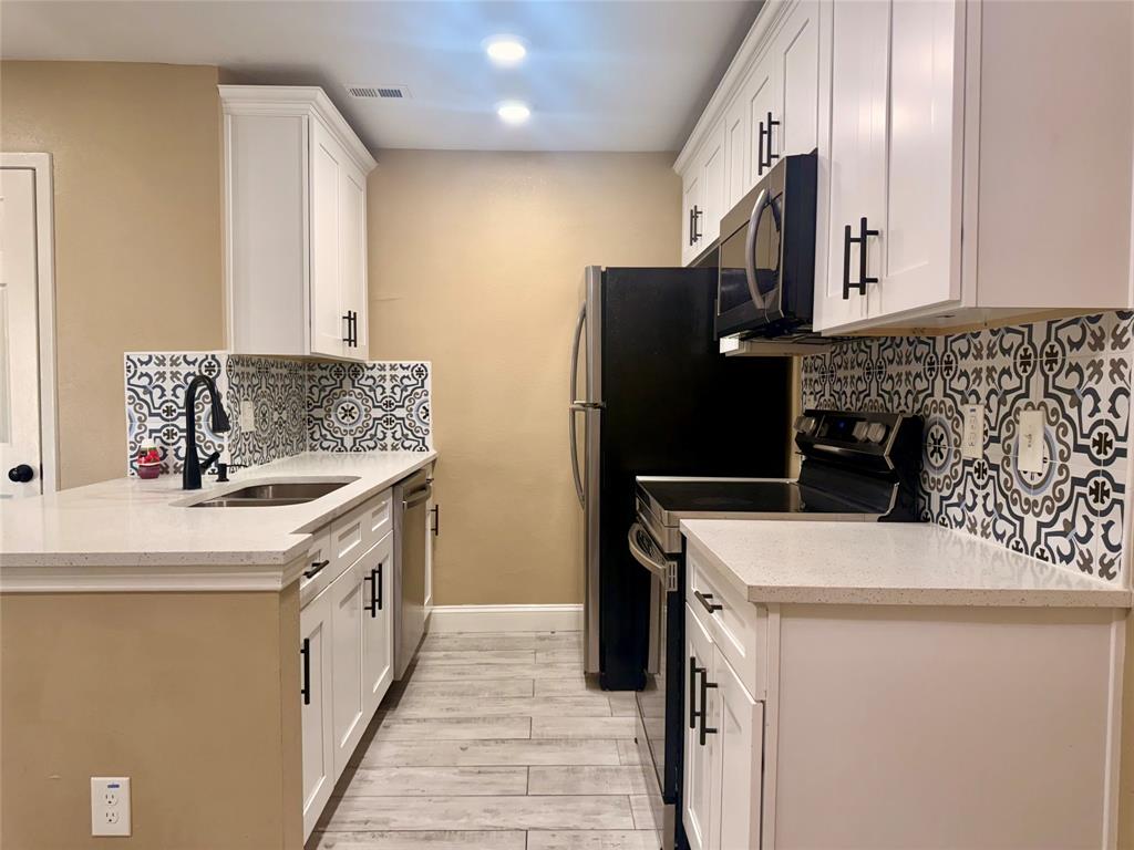 12802 Midway Road, Unit 2015 Dallas, TX 75244 - Photo 2 of 15 a kitchen that has a sink a stove and a refrigerator