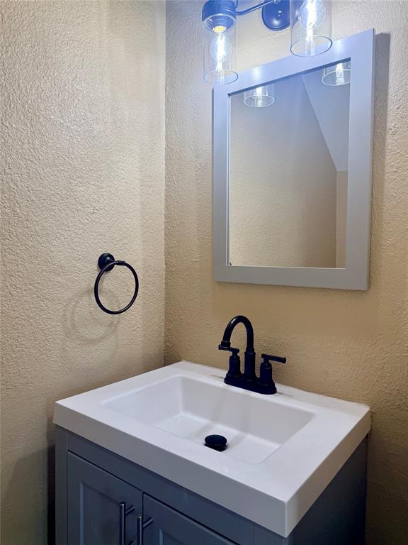 12802 Midway Road, Unit 2015 Dallas, TX 75244 - Photo 6 of 15 a bathroom with a sink mirror and vanity