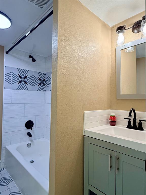 12802 Midway Road, Unit 2015 Dallas, TX 75244 - Photo 10 of 15 a bathroom with a sink and a tub