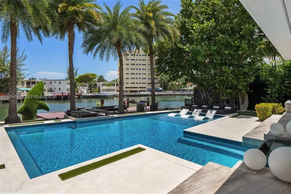 a view of a chairs and table in the balcony