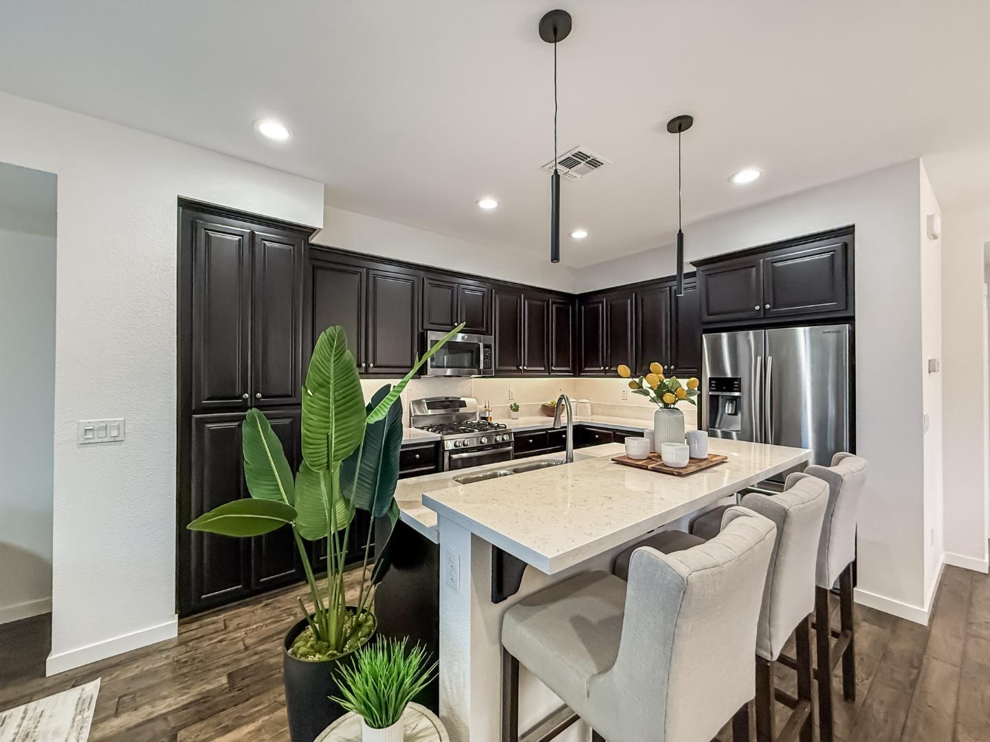 311 Geary Way Mountain View, CA 94041 - Photo 22 of 46 a kitchen with a table chairs refrigerator and microwave