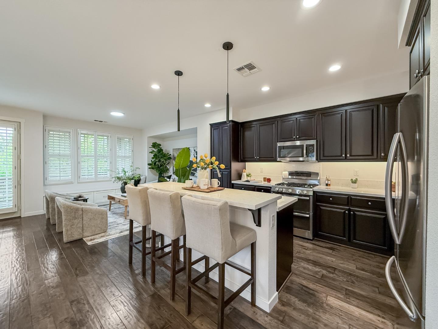 311 Geary Way Mountain View, CA 94041 - Photo 10 of 46 a kitchen with stainless steel appliances granite countertop a stove top oven a sink dishwasher a dining table and chairs with wooden floor