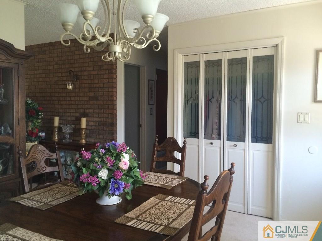 12 Temple Road Old Bridge, NJ 08859 - Photo 8 of 15 a view of a dining room with furniture and a chandelier