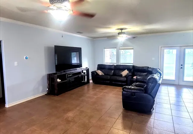 a living room with furniture and a flat screen tv