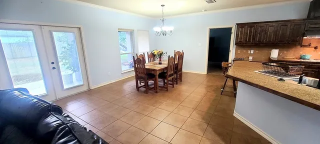 a kitchen with a dining table and chairs